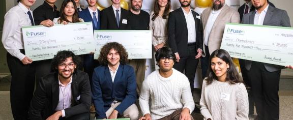 The winners of the 5th Annual Klaus Startup Challenge pose with their large cardboard checks from Fusen and the competition judges.