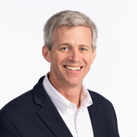 Tim Lieuwen headshot, smiling on a white background