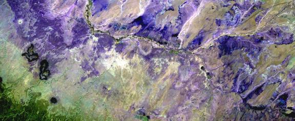 In the Painted Desert of Northern Arizona (shown here in a palette of purples), wet-dry cycling has contributed to the formation of the colorful layers visible in the landscape. (Credit: USGS)